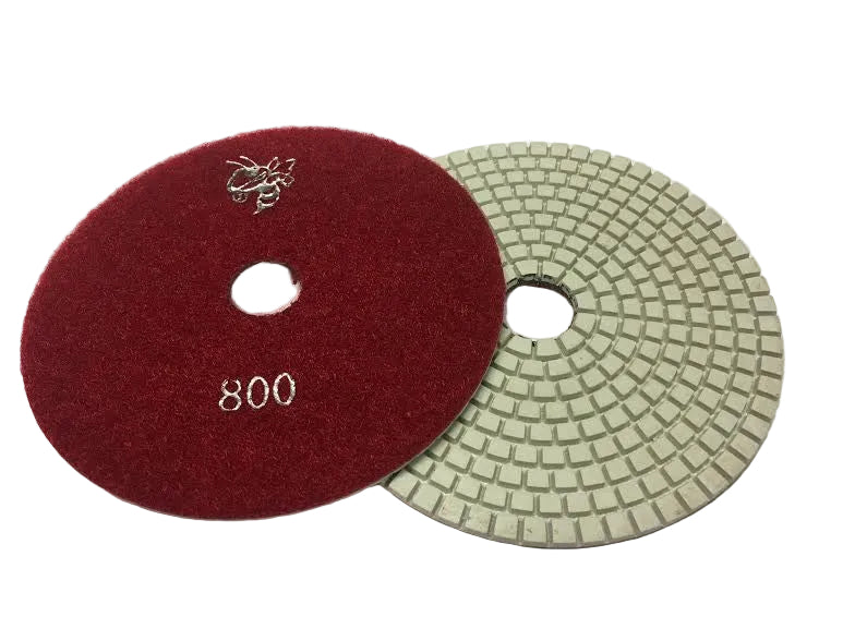 Red and green polishing pads on a white background